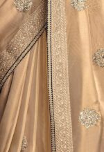 Shimmer Net Gold-coloured saree featuring an all-over heavy gold zari butta and sequence work on body decorated with border with contrast navy blue piping - Image 2